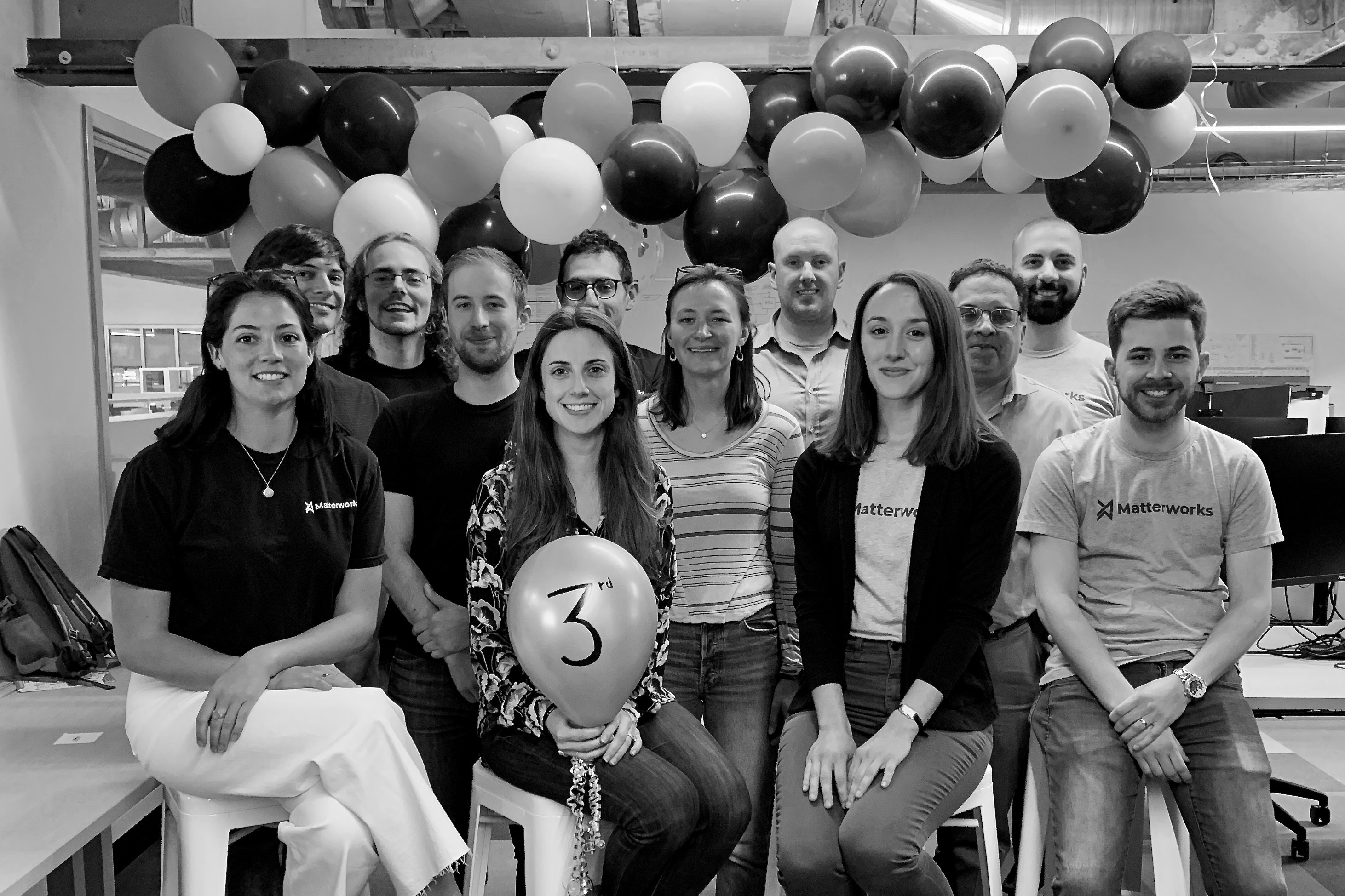 All-team photo in office space with balloons to celebrate 3rd Anniversary