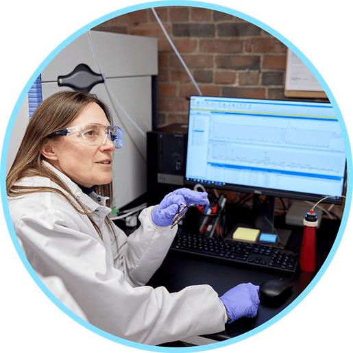 female scientist in front of desktop computer